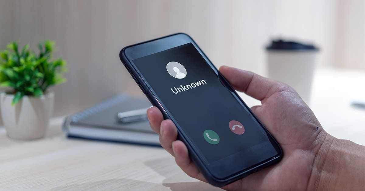 Smartphone displaying an incoming call from an unknown number.